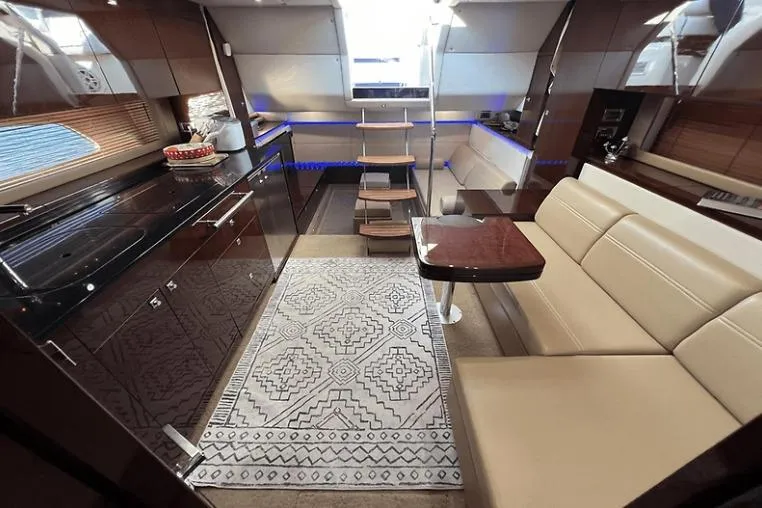 Slide: The Image of Luxurious interior of a 2010 Sea Ray 450 Sundancer yacht with modern kitchen and seating area. - 54
