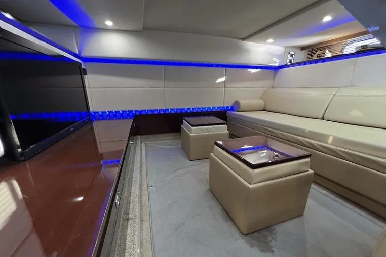 Slide: The Image of Luxurious interior of 2010 Sea Ray 450 Sundancer yacht with modern seating and ambient lighting. - 56
