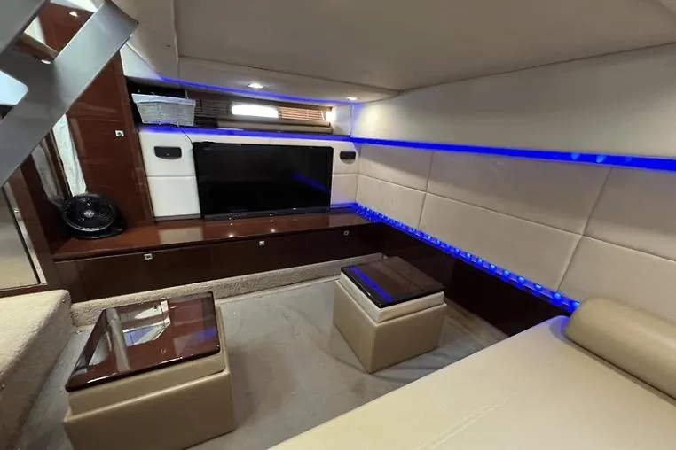 Slide: The Image of Luxurious interior of 2010 Sea Ray 450 Sundancer yacht with modern seating and ambient lighting. - 57