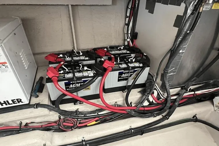 Slide: The Image of Battery compartment of a 2010 Sea Ray 450 Sundancer with AGM batteries and wiring. - 60