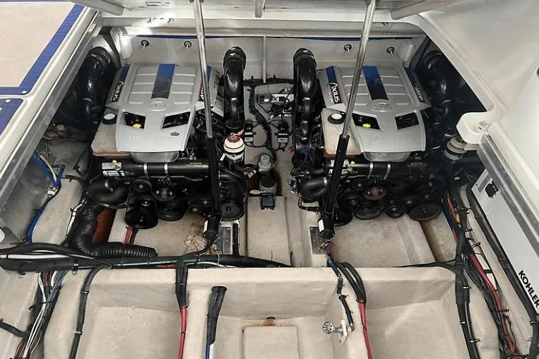 Slide: The Image of Engine room of 2010 Sea Ray 450 Sundancer with twin engines and visible wiring. - 62