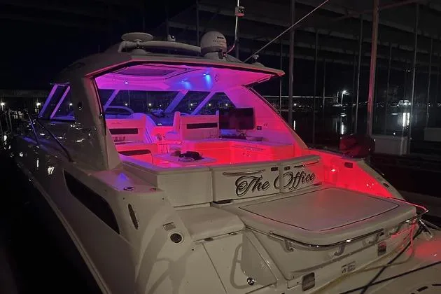 Slide: The Image of 2010 Sea Ray 450 Sundancer yacht with vibrant interior lighting at night. - 7