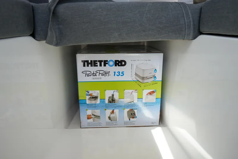 Slide: The Image of Thetford Porta Potti 135 box inside 2022 C-Dory 22' Cruiser boat. - 21