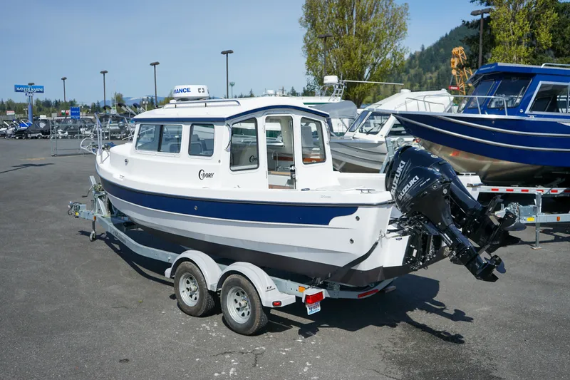 Slide: The Image of 2022 C-Dory 22' Cruiser boat on trailer, parked outdoors in a marina setting. - 3