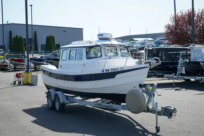 Slide: The Image of 2022 C-Dory 22' Cruiser on trailer in a marina parking lot. - 4