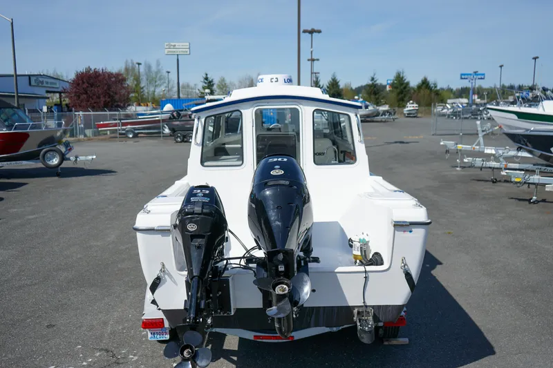 Slide: The Image of 2022 C-Dory 22' Cruiser with dual outboard motors in a parking lot. - 5