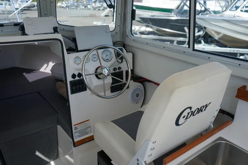 Slide: The Image of 2022 C-Dory 22' Cruiser interior with steering wheel and seating. - 9