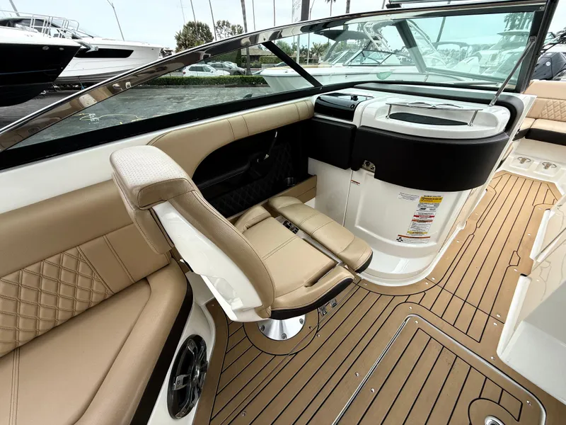 Slide: The Image of 2019 Sea Ray SLX 250 boat interior with tan seating and sleek design. - 10