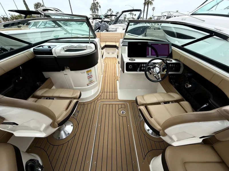 Slide: The Image of 2019 Sea Ray SLX 250 boat interior with luxurious seating and modern dashboard. - 11