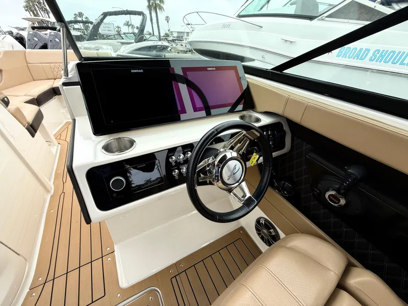 Slide: The Image of 2019 Sea Ray SLX 250 boat interior with modern dashboard and steering wheel. - 12