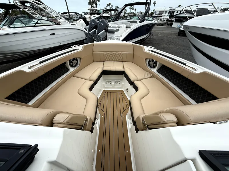Slide: The Image of 2019 Sea Ray SLX 250 boat with luxurious tan seating and sleek design. - 13