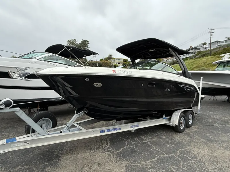 Slide: The Image of 2019 Sea Ray SLX 250 boat on trailer, black hull, parked outdoors. - 3