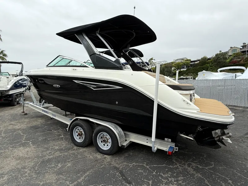 Slide: The Image of 2019 Sea Ray SLX 250 boat on trailer, black and white design, parked outdoors. - 4