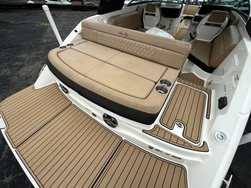 Slide: The Image of 2019 Sea Ray SLX 250 boat with tan seating and teak-style flooring. - 7
