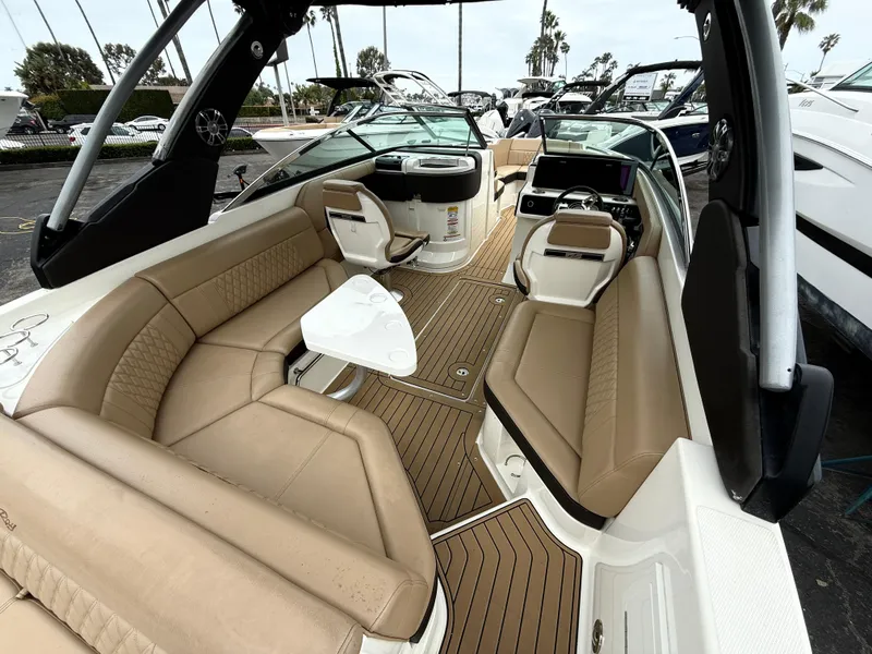 Slide: The Image of 2019 Sea Ray SLX 250 boat interior with tan seating and sleek design. - 8