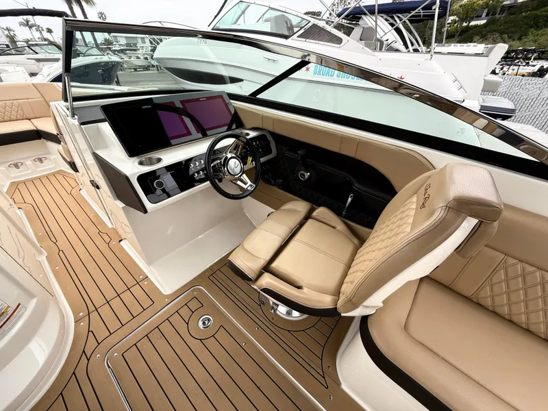 Slide: The Image of 2019 Sea Ray SLX 250 boat interior with luxurious seating and modern dashboard. - 9