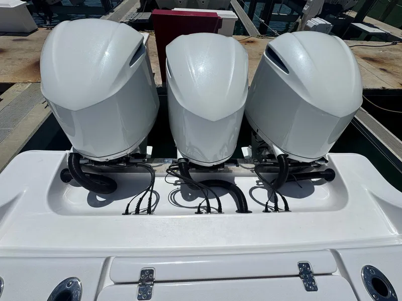 Slide: The Image of Three powerful outboard motors on a 2020 Sportsman Open 352 Center Console boat. - 1