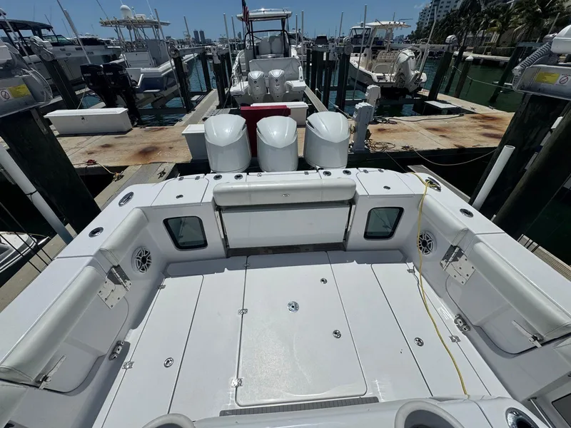 Slide: The Image of 2020 Sportsman Open 352 Center Console boat docked at marina, featuring spacious deck layout. - 2