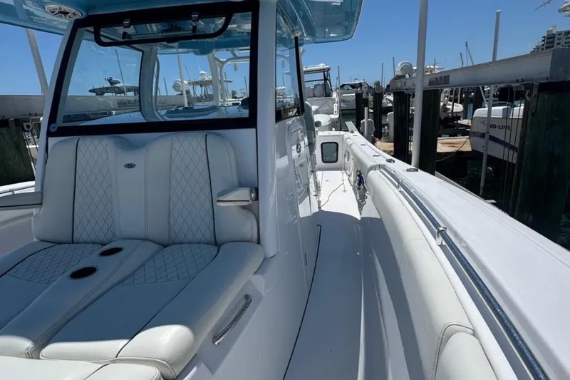 Slide: The Image of 2020 Sportsman Open 352 Center Console boat docked, featuring sleek white seating and modern design. - 7