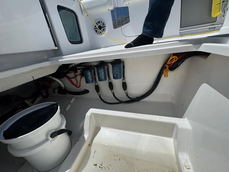 Slide: The Image of 2020 Sportsman Open 352 Center Console interior with wiring, filters, and a bucket. - 8