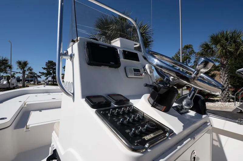 Slide: The Image of 2013 Pathfinder 2400 TRS boat console with steering wheel and controls, outdoors. - 12