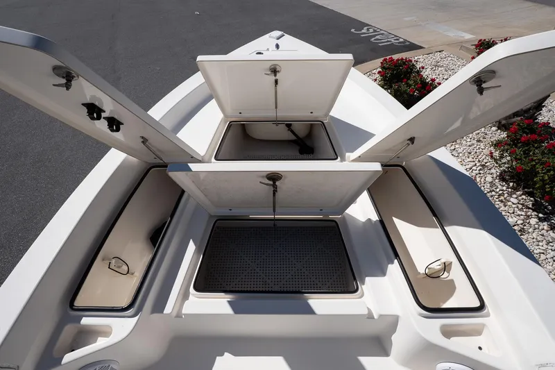 Slide: The Image of 2013 Pathfinder 2400 TRS boat storage compartments open, showcasing spacious interior design. - 17