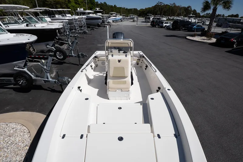 Slide: The Image of 2013 Pathfinder 2400 TRS boat in a marina, showcasing spacious deck and seating. - 19