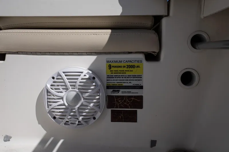 Slide: The Image of Speaker and capacity label on 2013 Pathfinder 2400 TRS boat interior. - 20