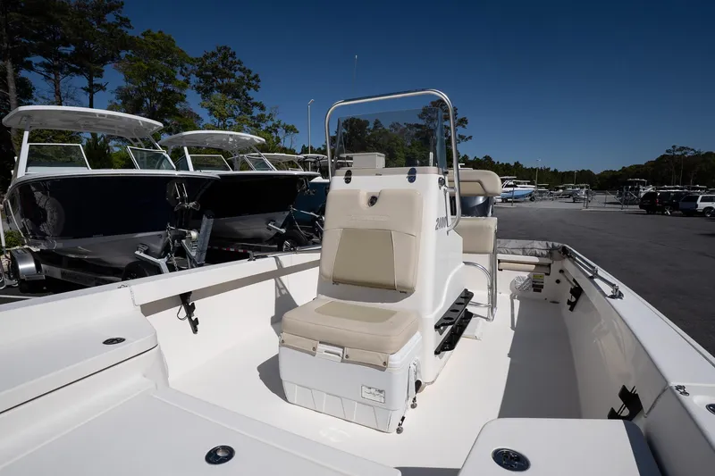 Slide: The Image of Pathfinder 2400 TRS 2013 boat with center console and seating, docked under clear blue sky. - 21