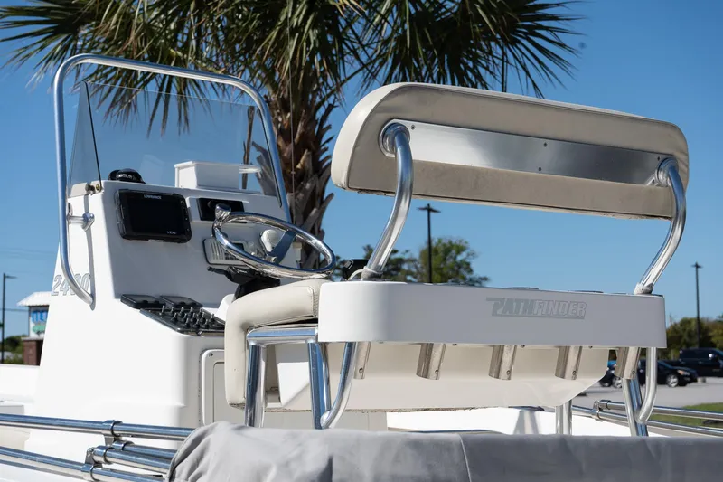 Slide: The Image of 2013 Pathfinder 2400 TRS boat console and seating under a palm tree. - 22