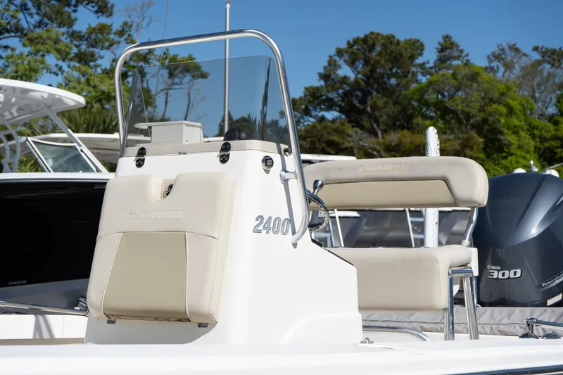 Slide: The Image of Pathfinder 2400 TRS boat console, 2013 model, with seating and motor, outdoors. - 24