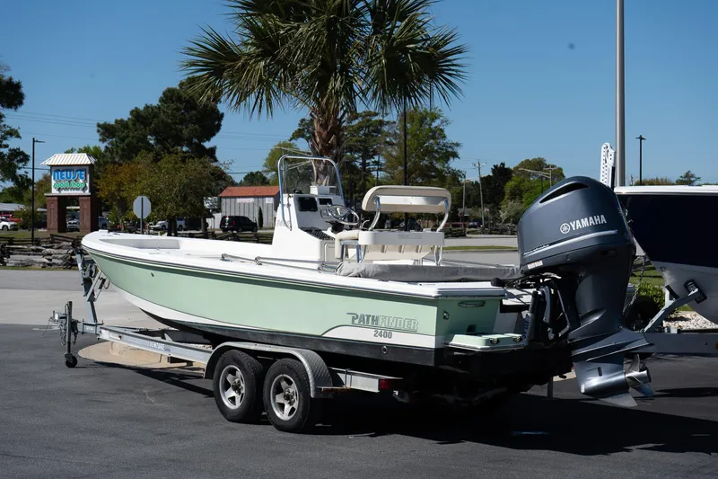 Slide: The Image of 2013 Pathfinder 2400 TRS boat on trailer with Yamaha outboard motor, parked outdoors. - 3
