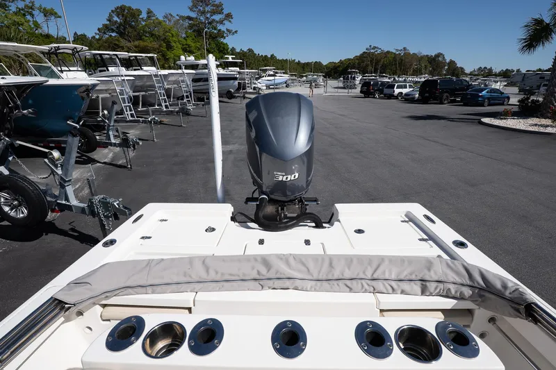 Slide: The Image of 2013 Pathfinder 2400 TRS boat with 300 HP engine in a marina setting. - 5