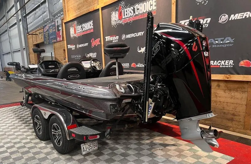 Slide: The Image of 2019 Triton 21 TrX boat with powerful outboard motor in showroom setting. - 3