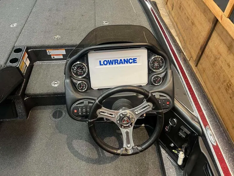 Slide: The Image of 2019 Triton 21 TrX boat dashboard with Lowrance display and steering wheel. - 5