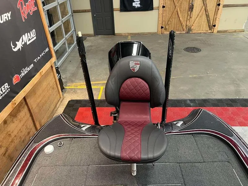 Slide: The Image of 2019 Triton 21 TrX boat seat in a showroom with branded walls. - 8