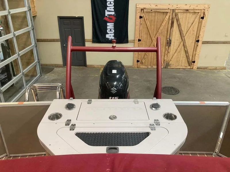 Slide: The Image of 2016 South Bay 521 FCR boat with outboard motor in a garage setting. - 10