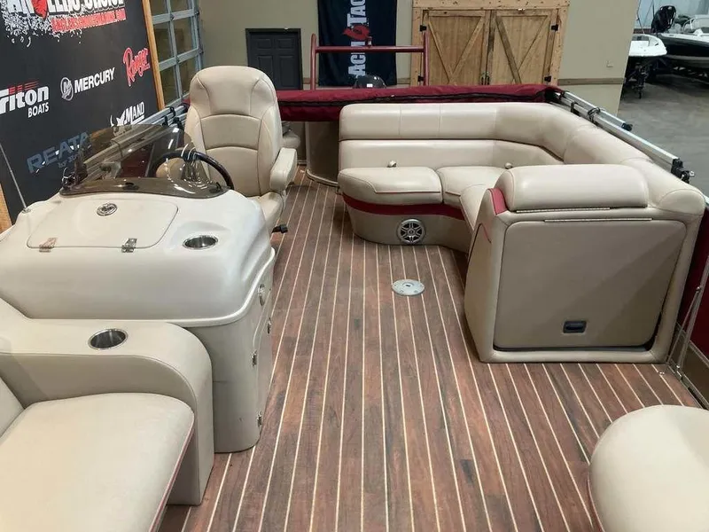 Slide: The Image of 2016 South Bay 521 FCR boat interior with beige seating and wood flooring. - 6
