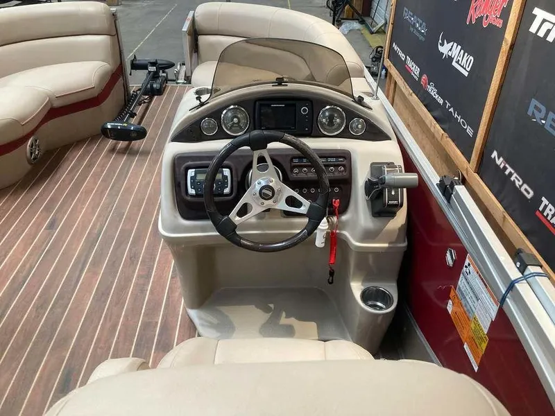 Slide: The Image of 2016 South Bay 521 FCR boat interior with steering console and seating. - 7