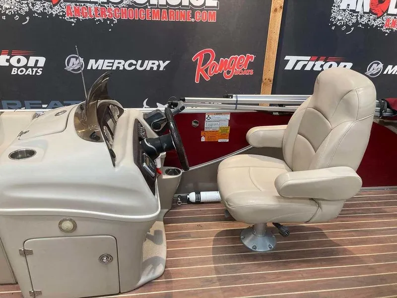 Slide: The Image of Captain's chair and console of 2016 South Bay 521 FCR boat on wooden deck. - 9