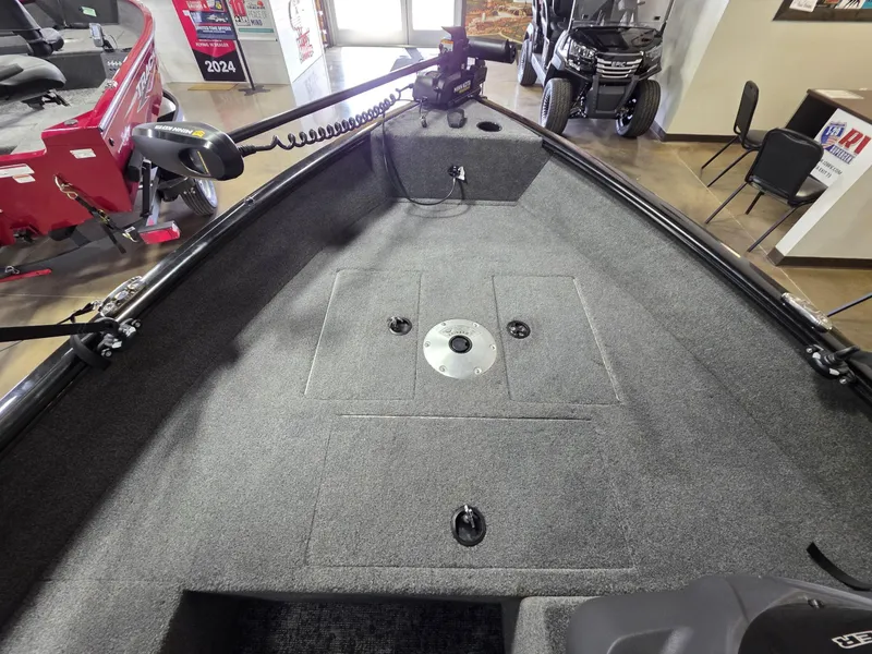 Slide: The Image of 2024 Tracker Super Guide V-16 SC boat interior with carpeted deck and mounted equipment. - 4