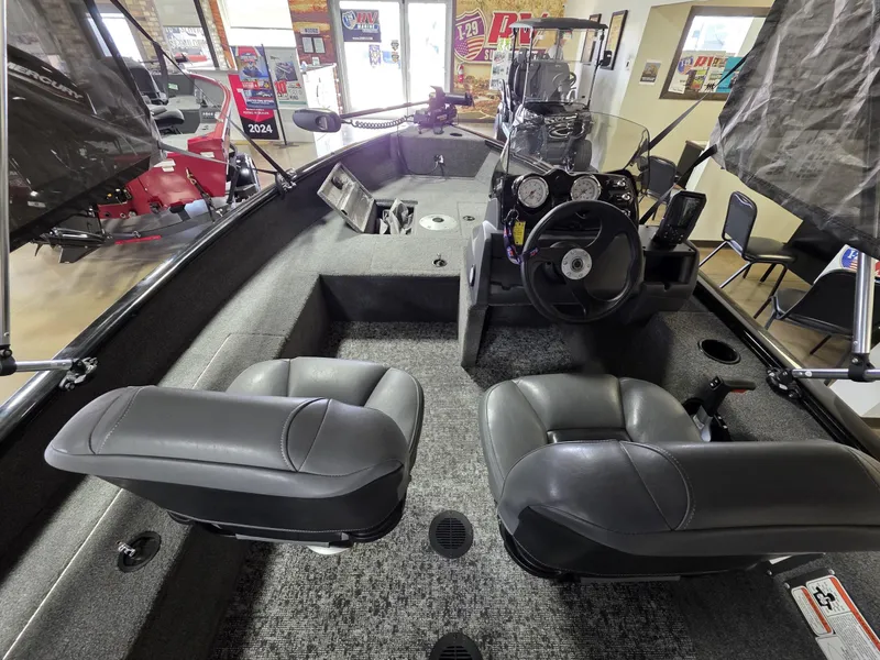 Slide: The Image of 2024 Tracker Super Guide V-16 SC boat interior with dual seats and steering console. - 5