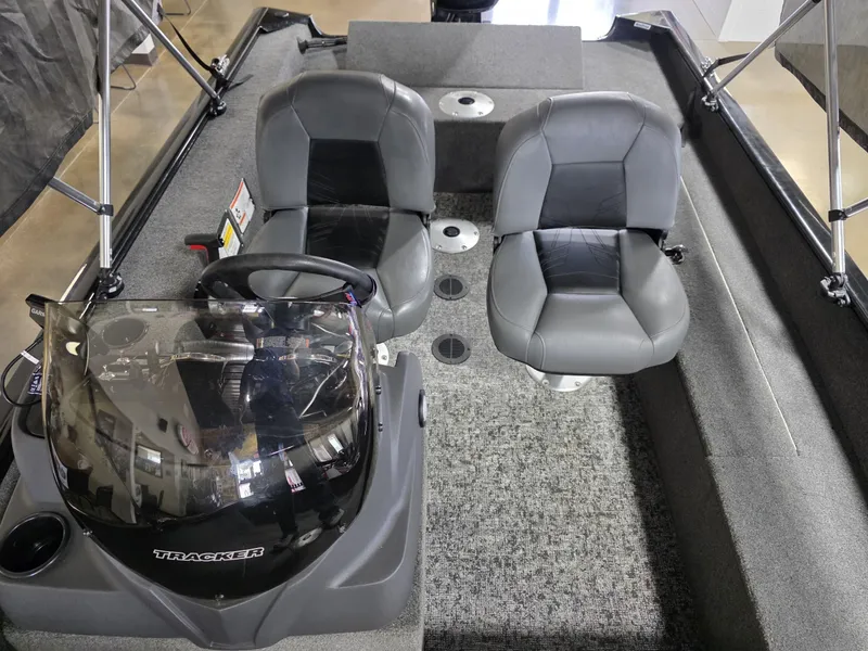 Slide: The Image of 2024 Tracker Super Guide V-16 SC boat interior with dual seats and steering console. - 8