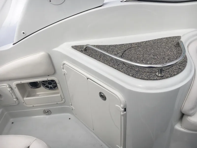 Slide: The Image of 2018 Crownline 264 CR boat interior with storage compartment and speaker. - 13