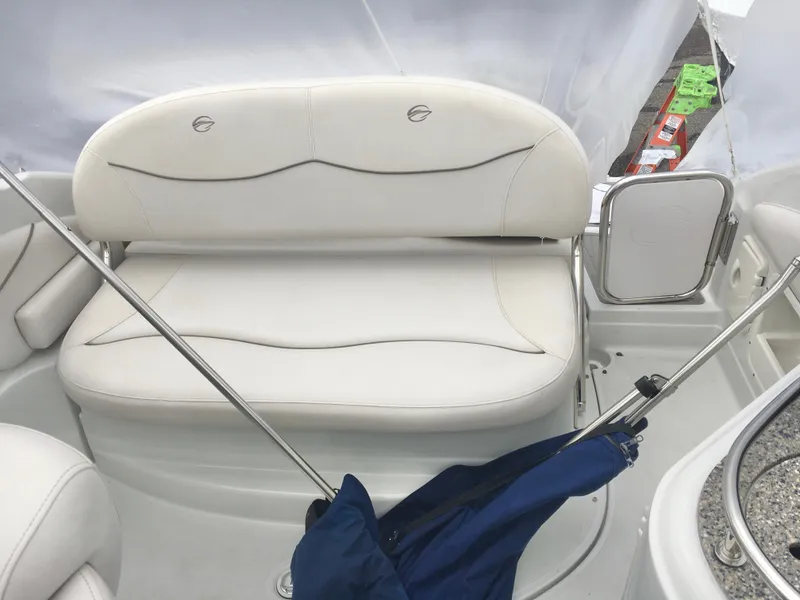 Slide: The Image of 2018 Crownline 264 CR boat interior with white seating and umbrella. - 15