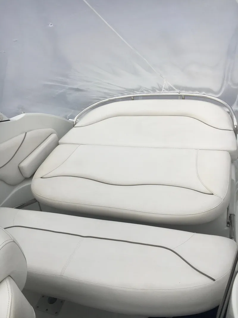 Slide: The Image of 2018 Crownline 264 CR boat interior with white cushioned seating. - 16