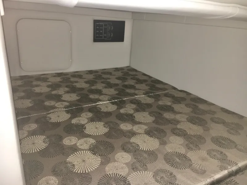 Slide: The Image of 2018 Crownline 264 CR cabin interior with patterned upholstery. - 26