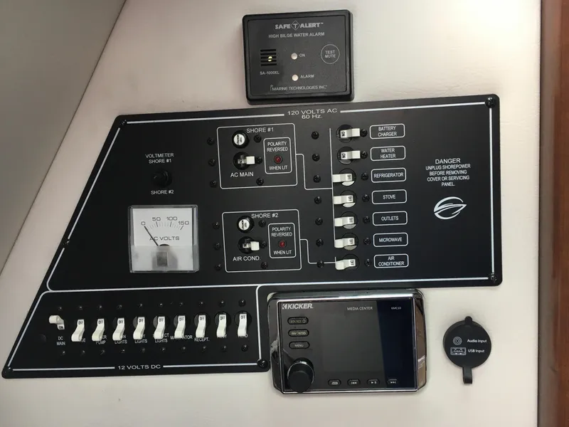 Slide: The Image of Control panel of a 2018 Crownline 264 CR boat with various switches and gauges. - 27