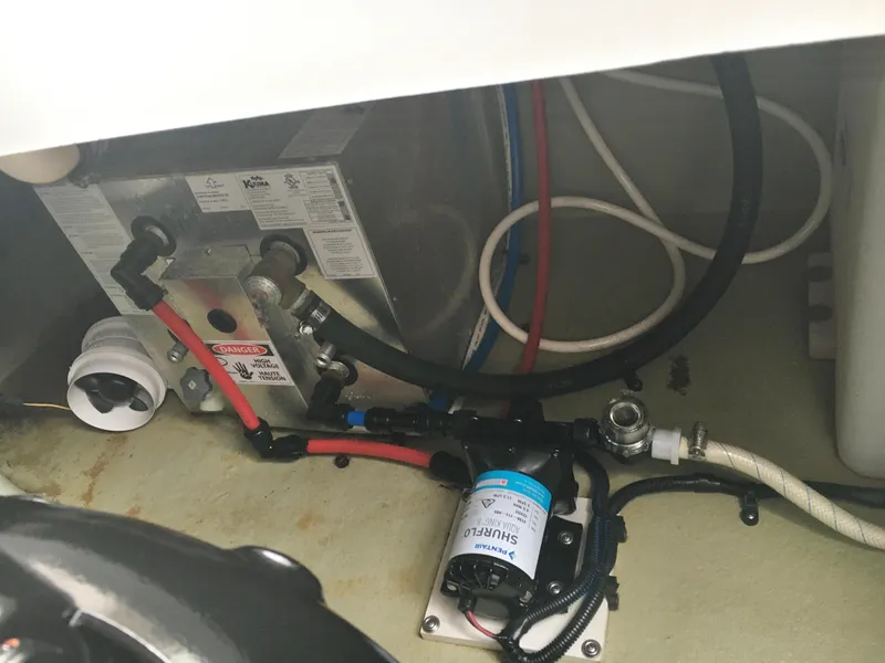 Slide: The Image of 2018 Crownline 264 CR boat engine compartment with visible wiring and components. - 31