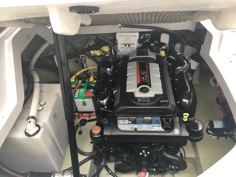 Slide: The Image of Engine compartment of a 2018 Crownline 264 CR boat, featuring a powerful engine setup. - 32